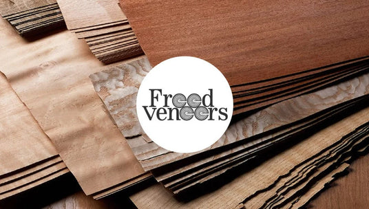 Wooden veneer samples with Freed Veneers logo in the center