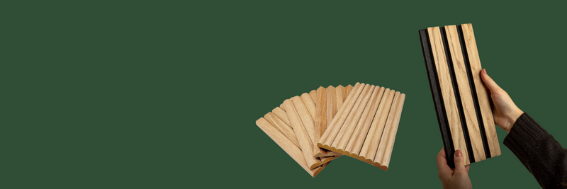 Plain green background with a persons hand holding a Acupanel acoustic slat wood wall panel in Natural Oak. Then next to it is a spread out pile of Flutto flexible tambour wood wall panel samples in American Oak